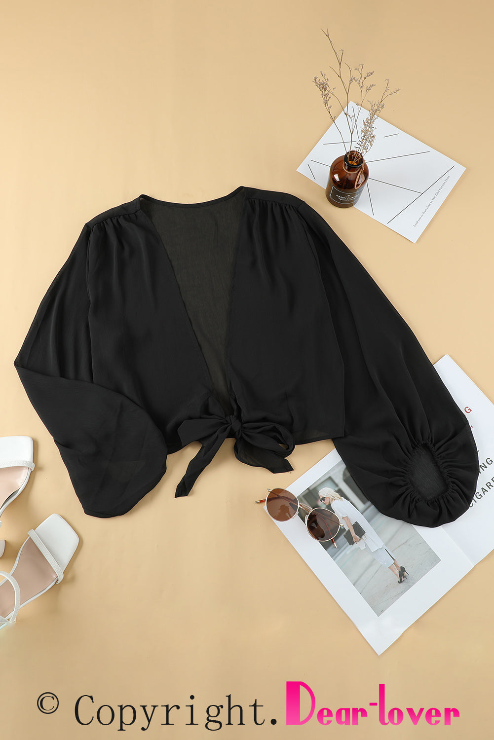 Black Plus Size Balloon Sleeve Wrap Top featuring a v-neck and tie front design, elegantly styled with balloon sleeves.