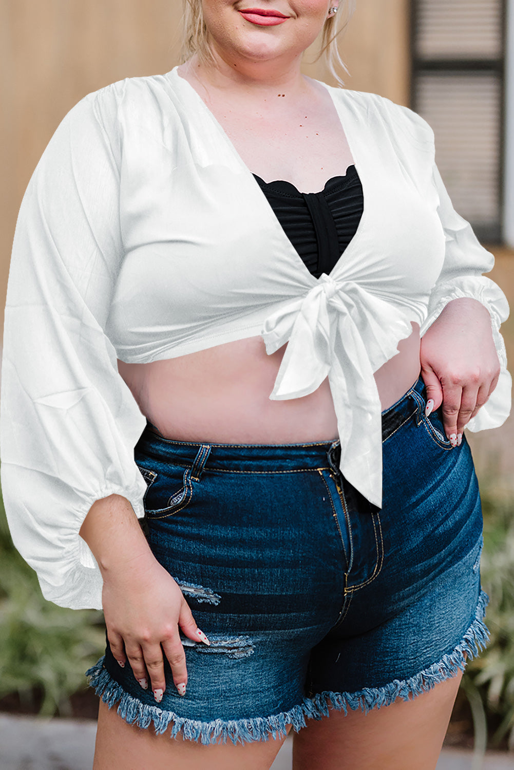 Black Plus Size Balloon Sleeve Wrap Top featuring a v-neck and tie front design, elegantly styled with balloon sleeves.