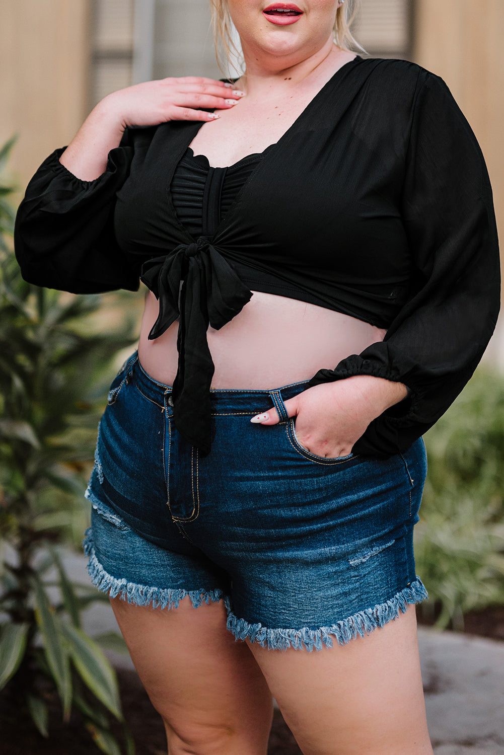 Black Plus Size Balloon Sleeve Wrap Top featuring a v-neck and tie front design, elegantly styled with balloon sleeves.