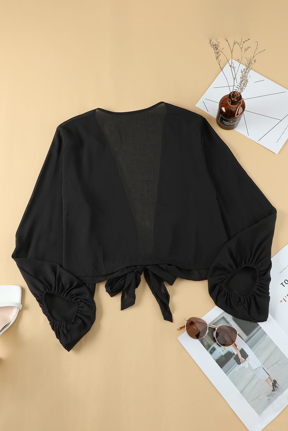 Black Plus Size Balloon Sleeve Wrap Top featuring a v-neck and tie front design, elegantly styled with balloon sleeves.