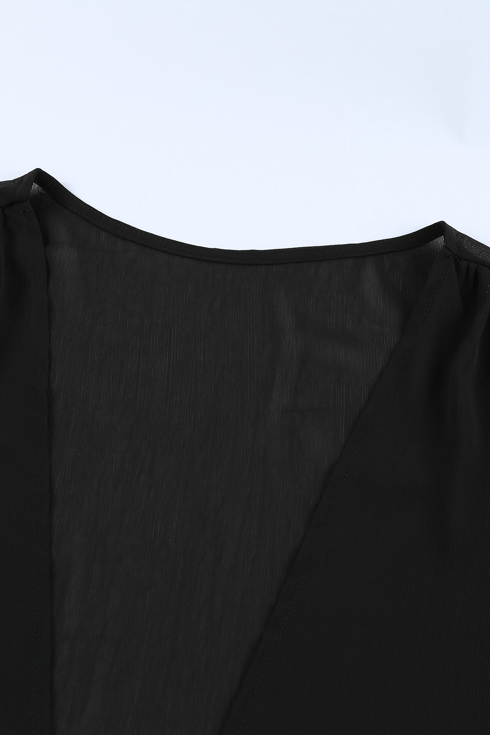 Black Plus Size Balloon Sleeve Wrap Top featuring a v-neck and tie front design, elegantly styled with balloon sleeves.