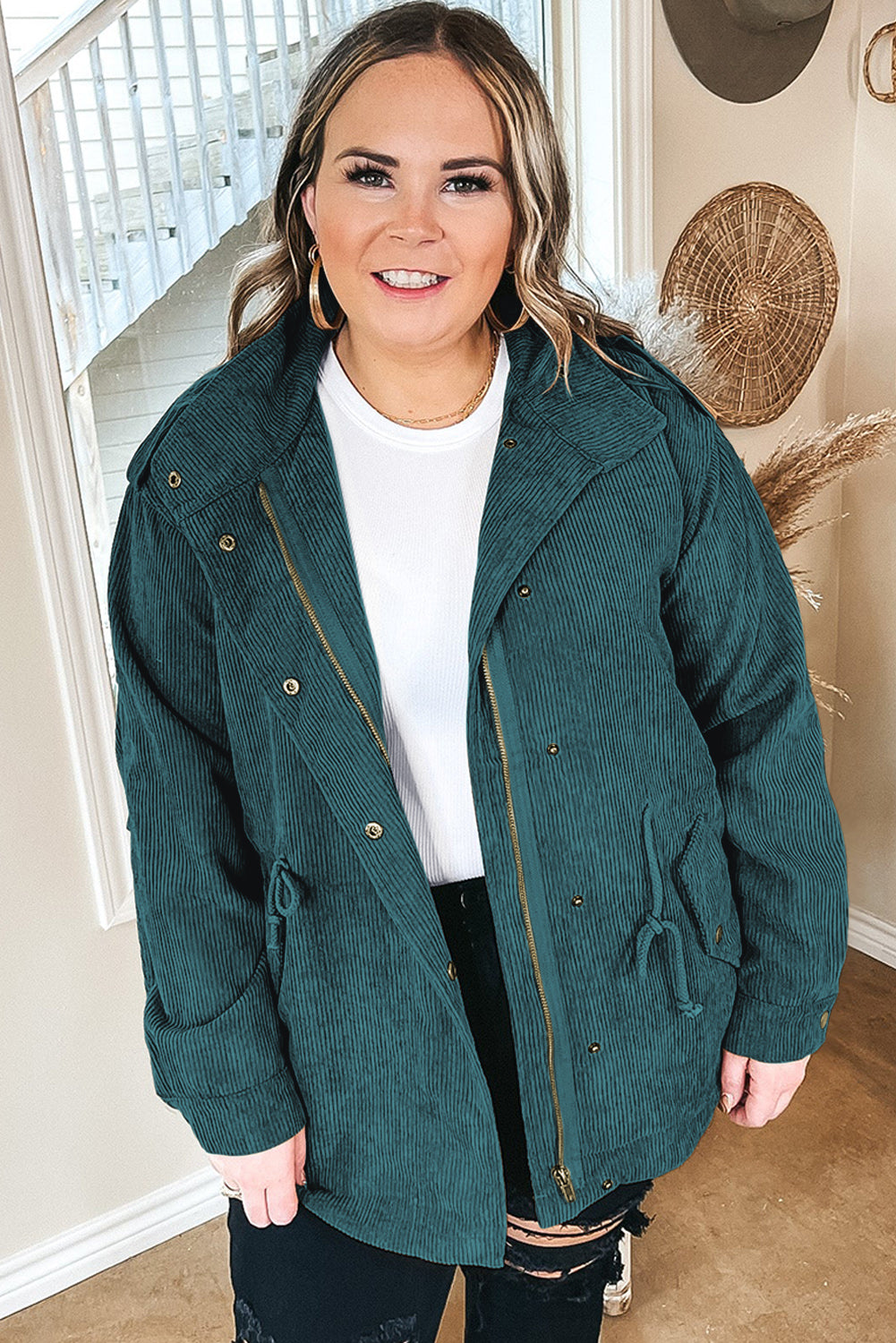 Black plus size corduroy jacket with button and zipper closures, featuring shoulder tabs and flap pockets, designed for curvy women.