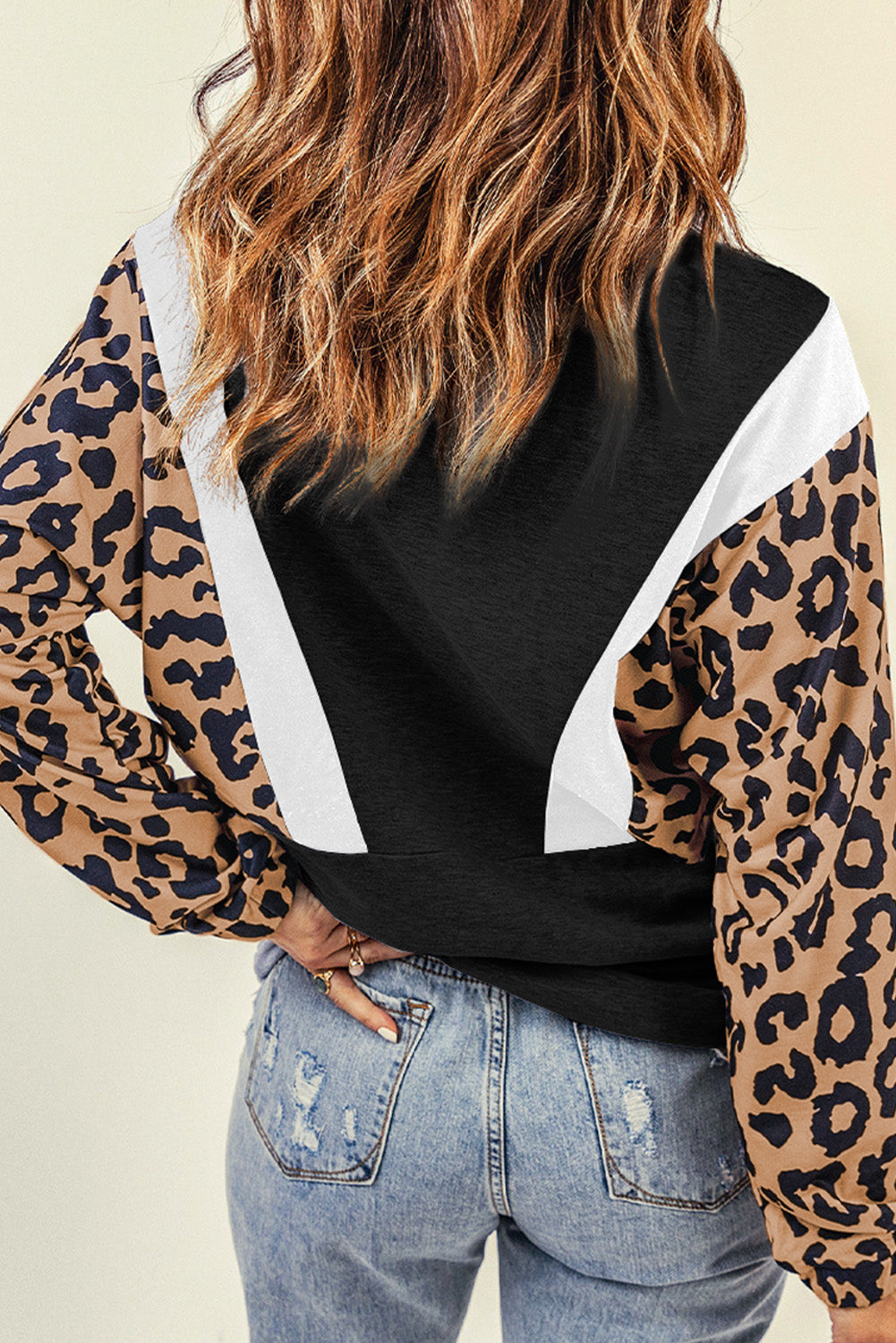 Black Pocketed Half Zip Leopard Pullover Sweatshirt featuring trendy leopard panels and a relaxed fit, perfect for casual wear.