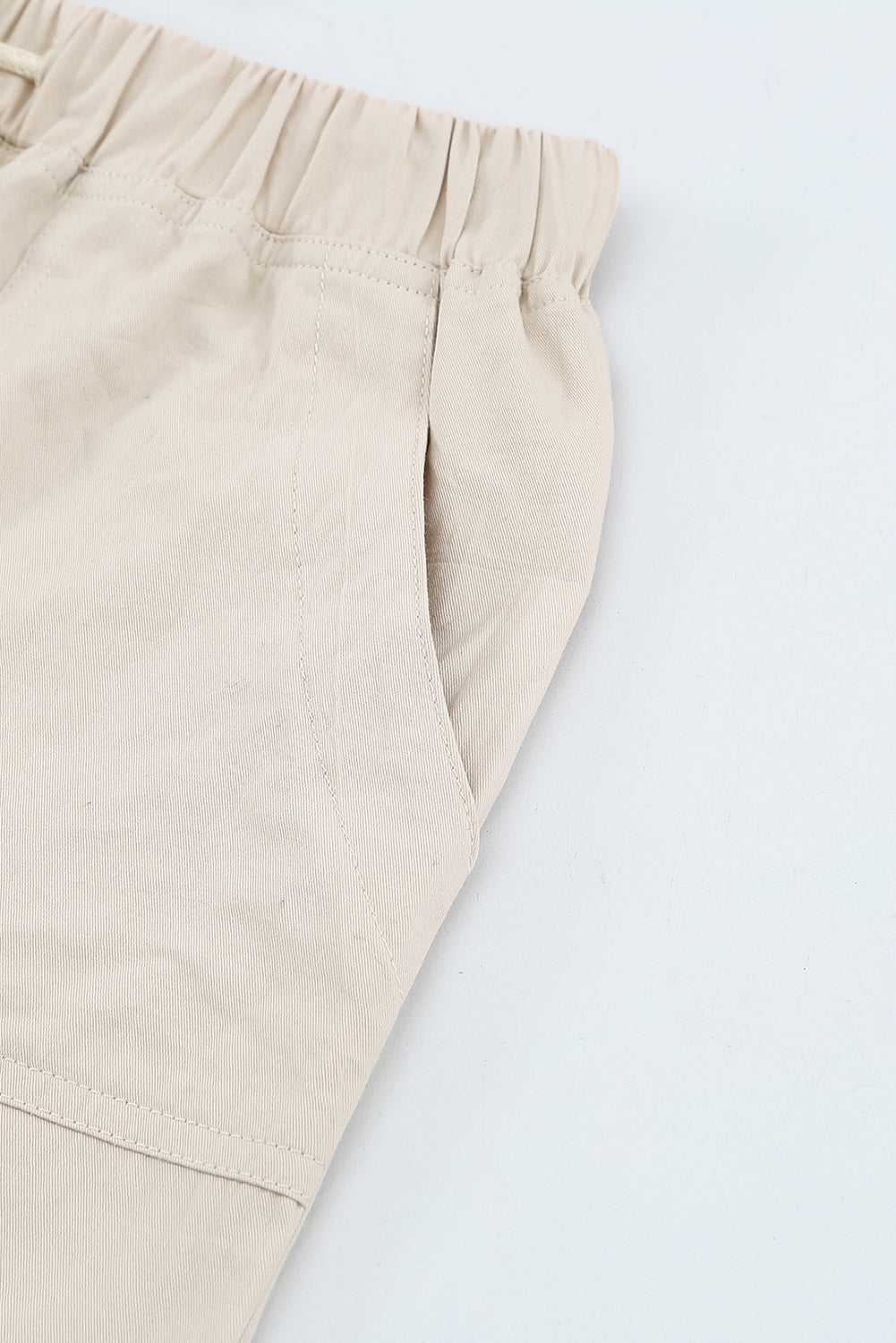 Black casual shorts with raw hem and pockets, featuring a drawstring waist for adjustable fit.