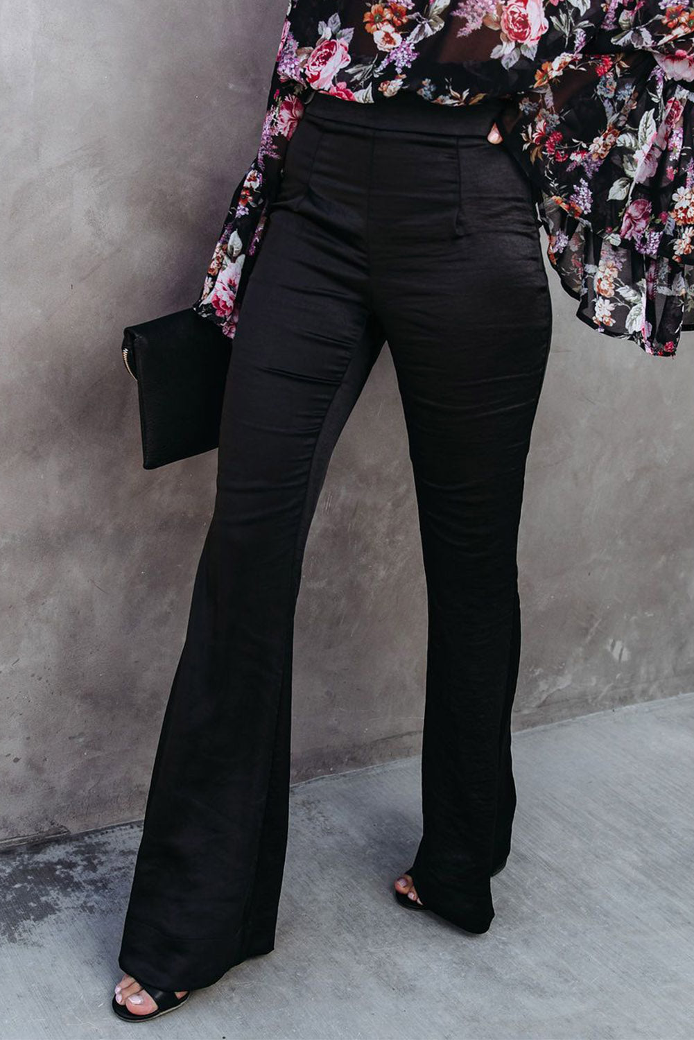 A pair of elegant black satin flare tailored pants with a high waist and pleated details, showcasing a luxurious fabric and stylish silhouette.