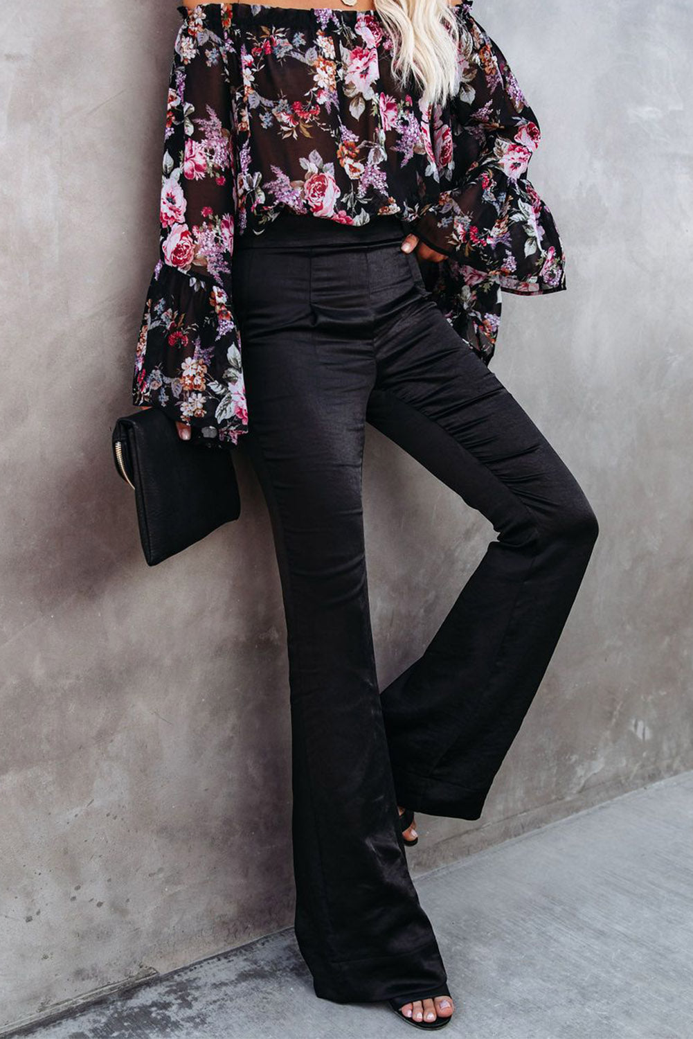 A pair of elegant black satin flare tailored pants with a high waist and pleated details, showcasing a luxurious fabric and stylish silhouette.