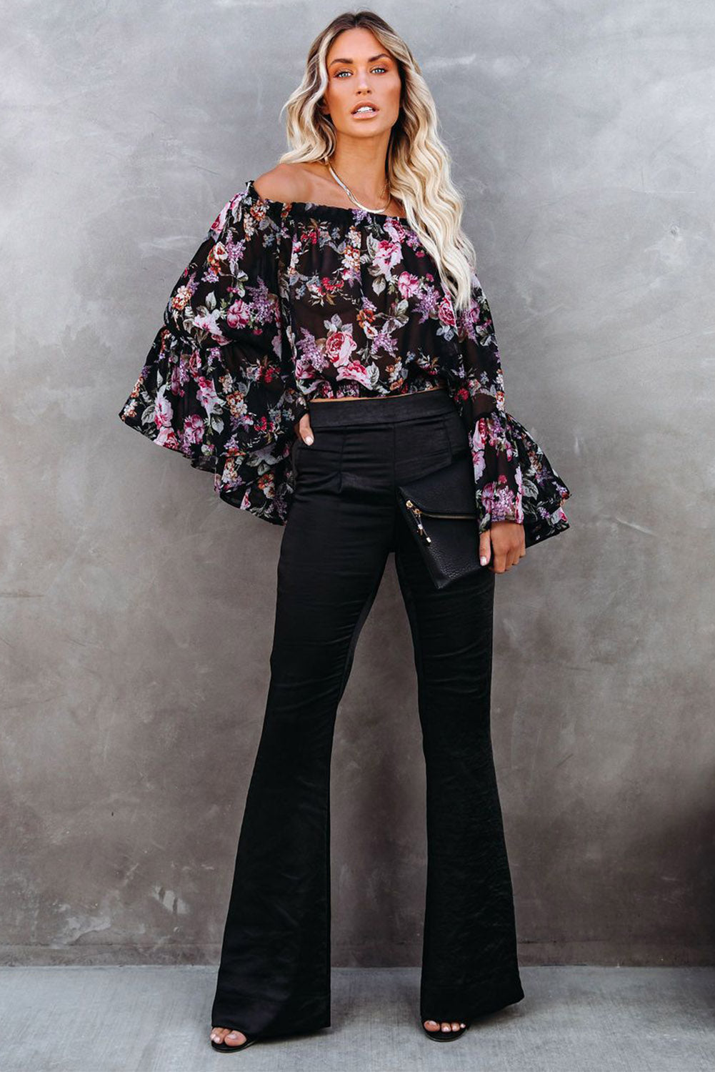 A pair of elegant black satin flare tailored pants with a high waist and pleated details, showcasing a luxurious fabric and stylish silhouette.