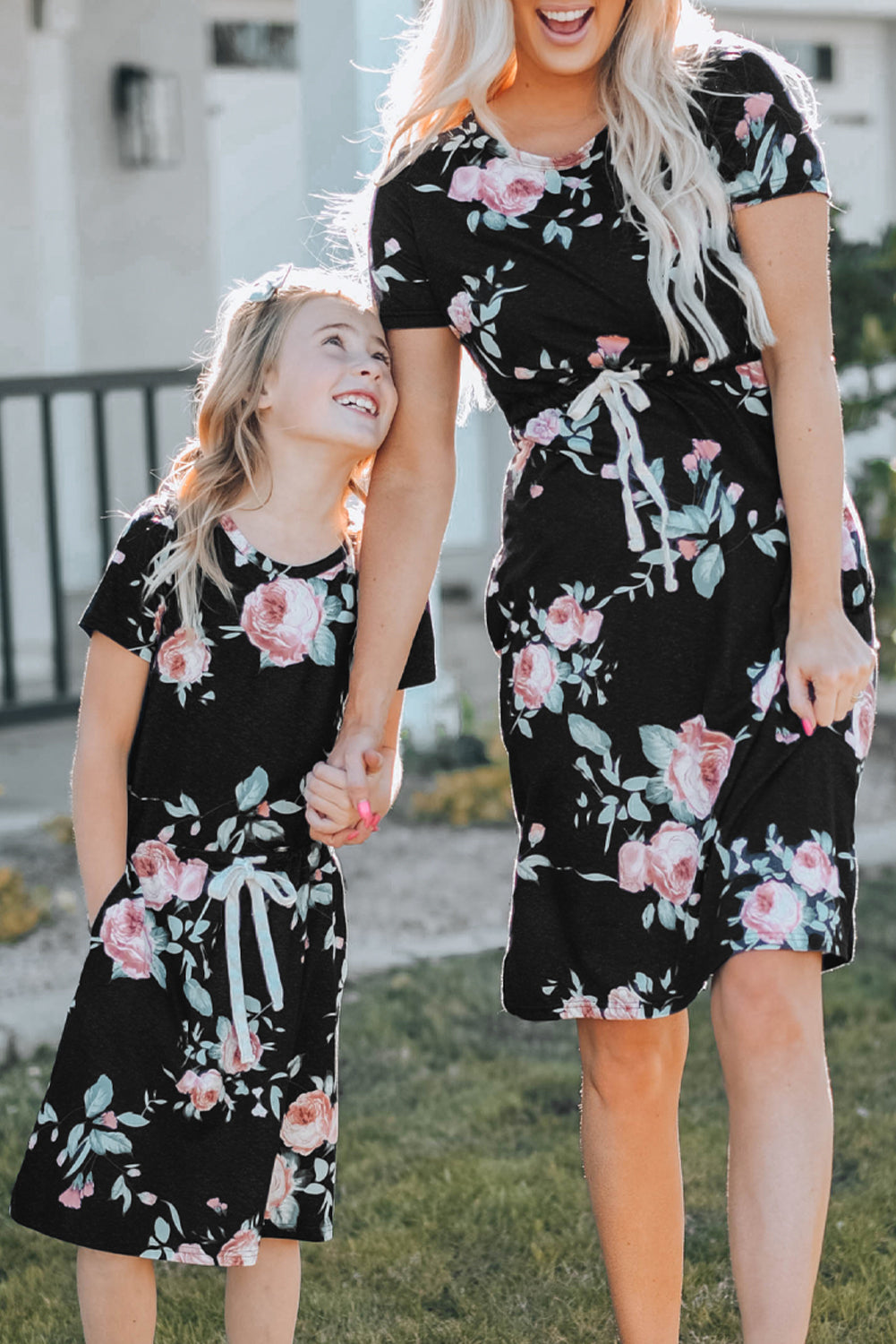 Black short sleeve casual floral dress with pockets and drawstring waist, perfect for summer outings.