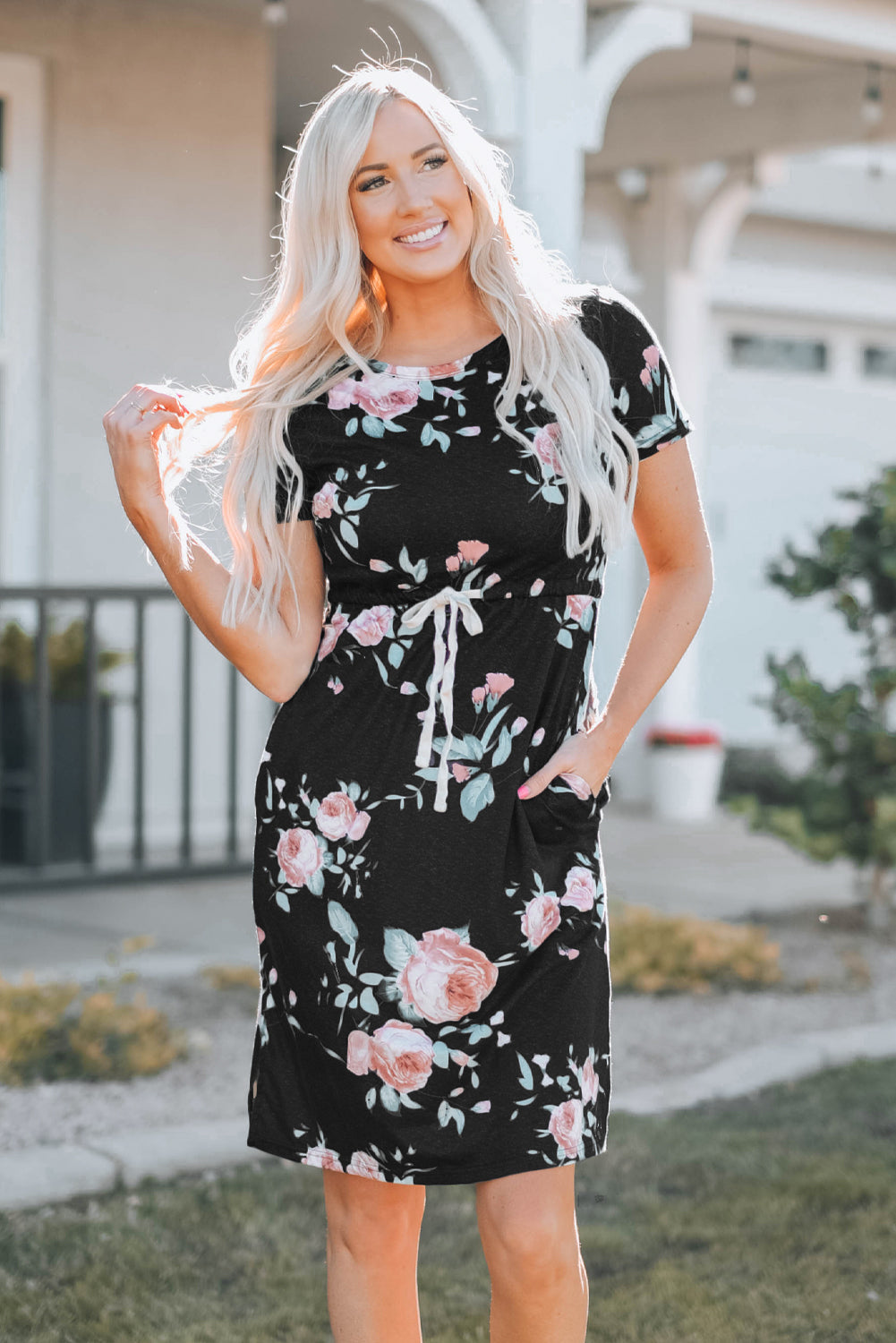 Black short sleeve casual floral dress with pockets and drawstring waist, perfect for summer outings.