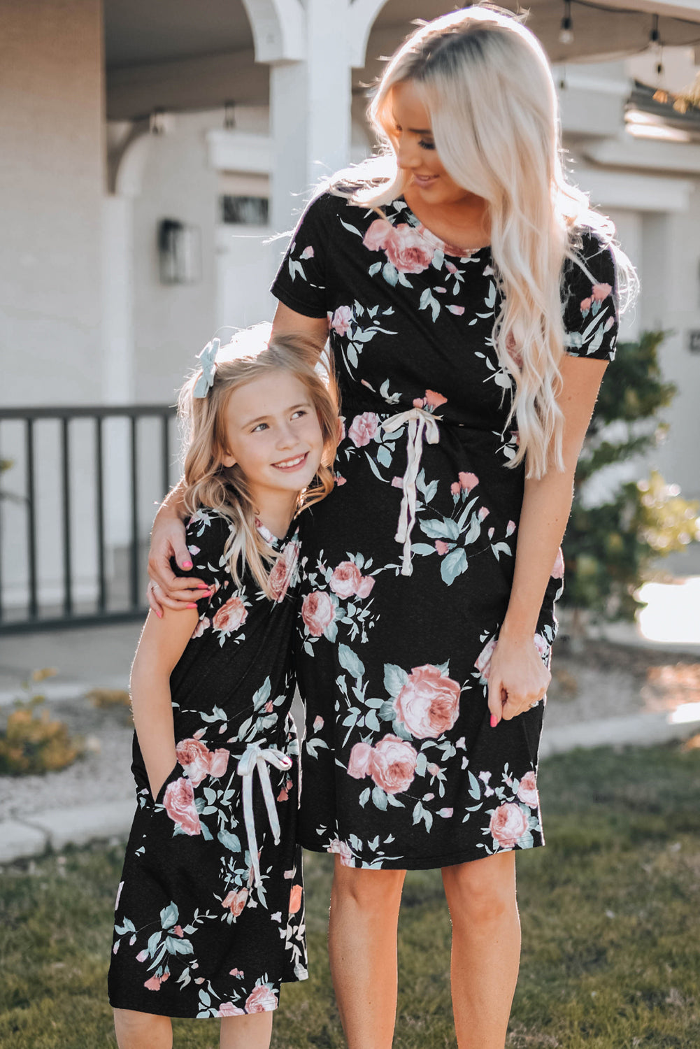 Black short sleeve casual floral dress with pockets and drawstring waist, perfect for summer outings.