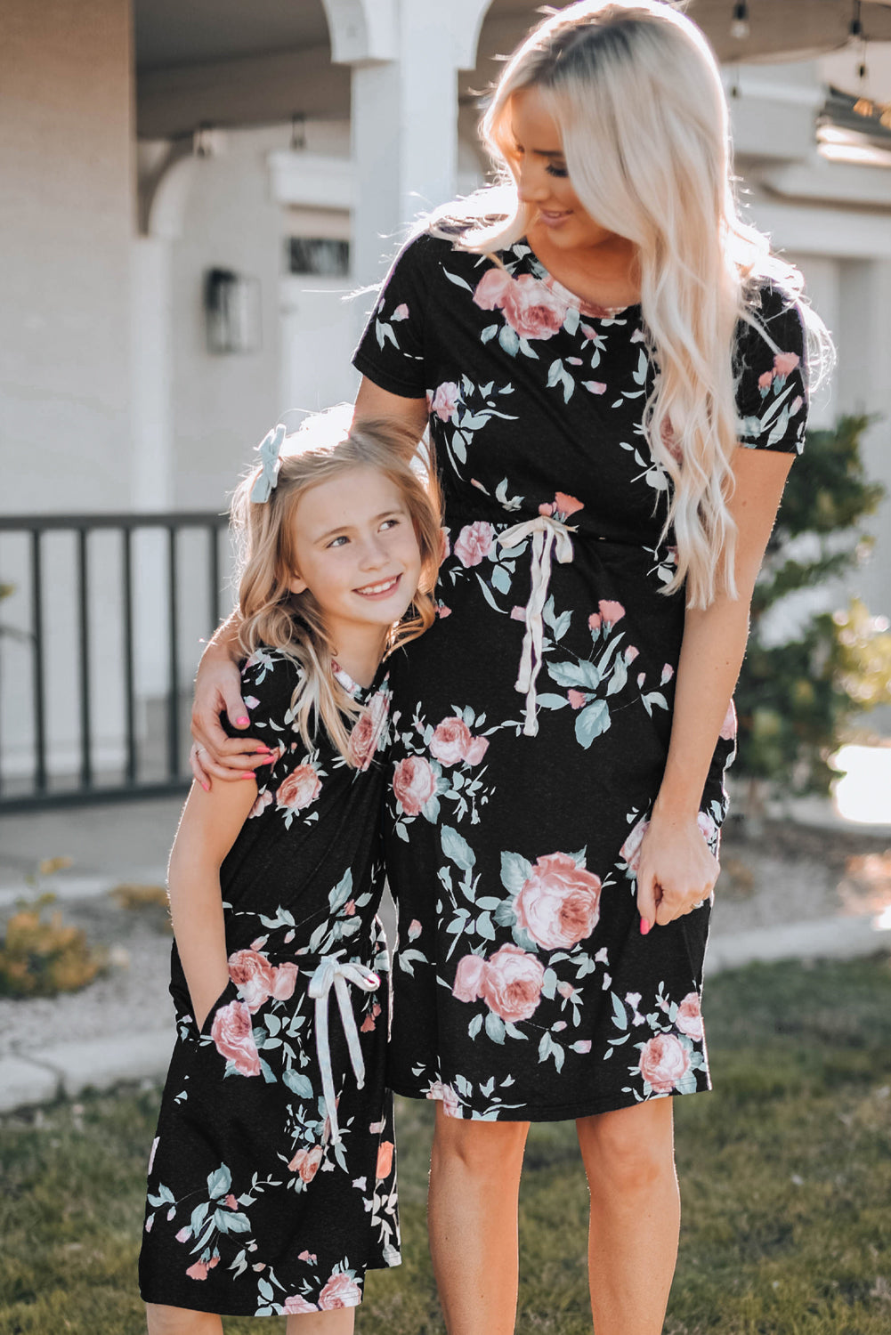 Black short sleeve casual floral dress with pockets and drawstring waist, perfect for summer outings.