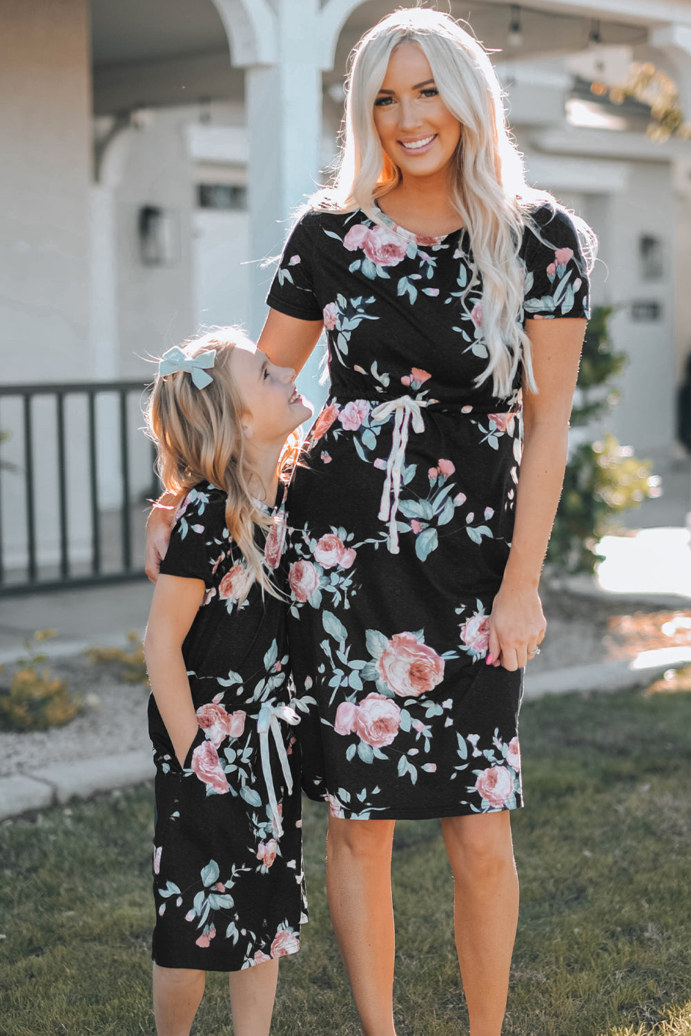 Black short sleeve casual floral dress with pockets and drawstring waist, perfect for summer outings.