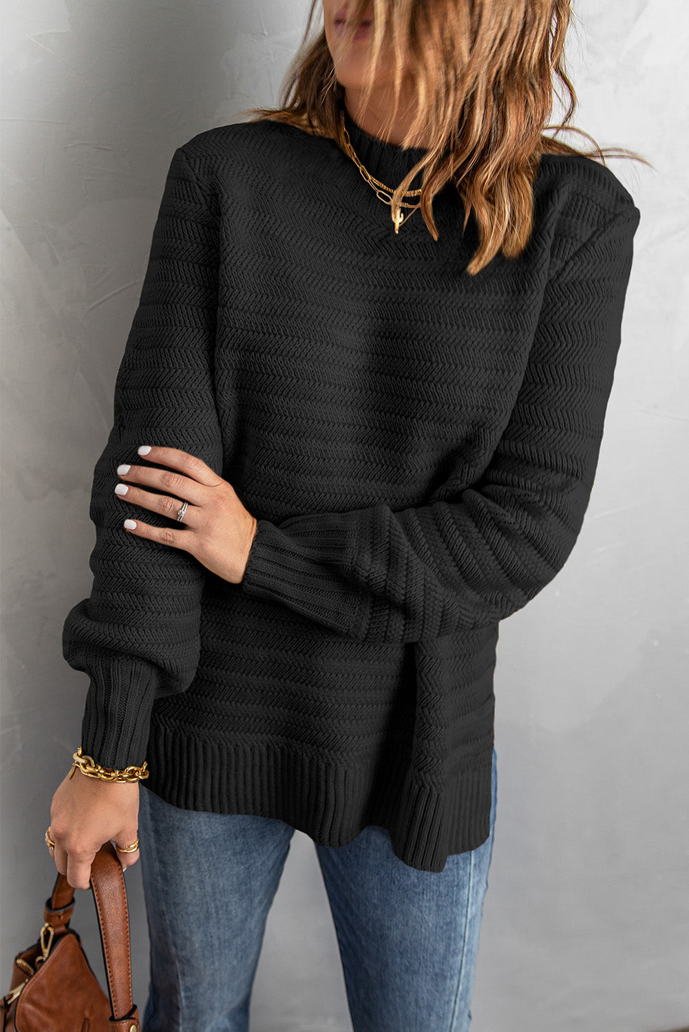 Black solid color sweater with stand collar and textured fabric, featuring long sleeves and a loose fit design.