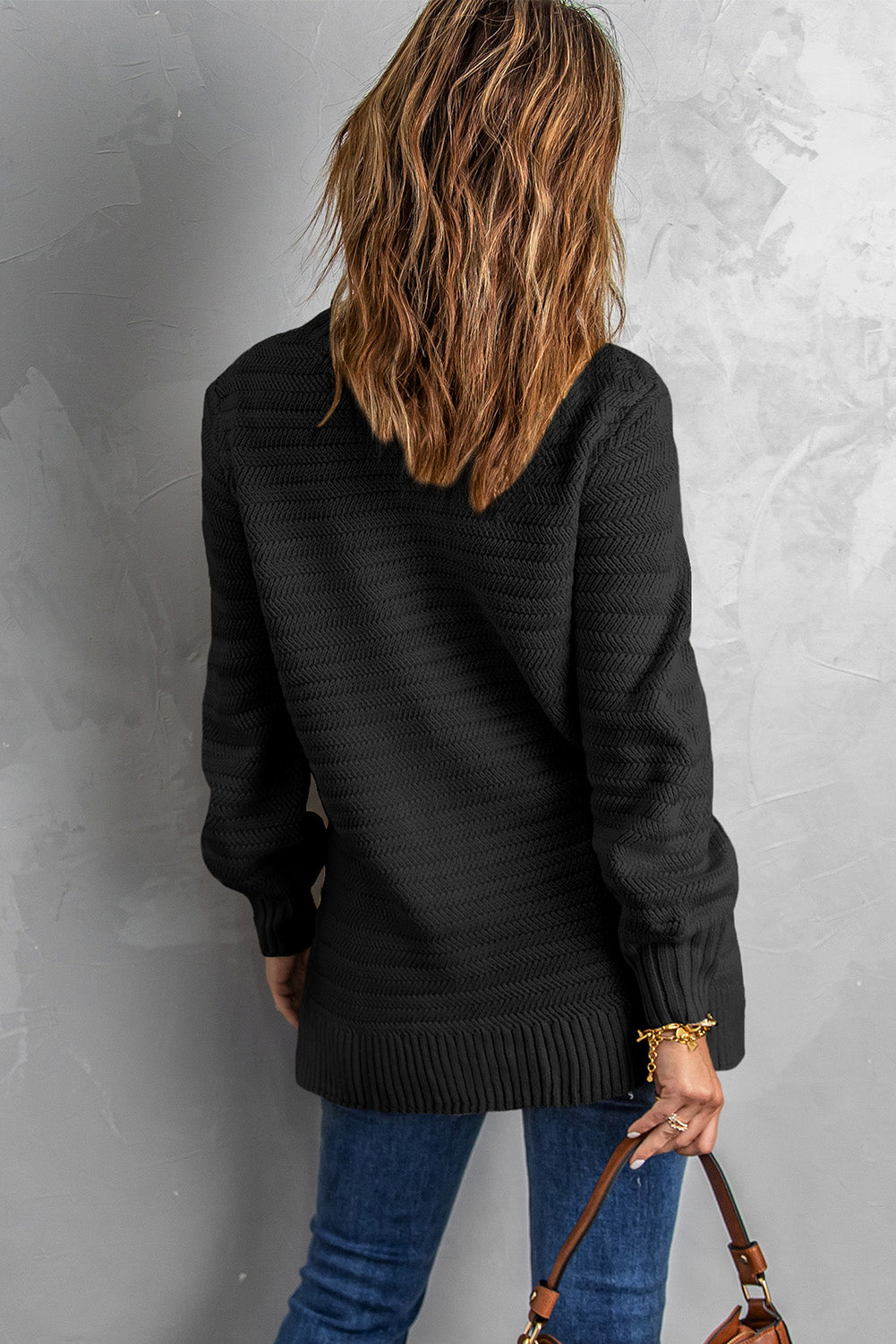 Black solid color sweater with stand collar and textured fabric, featuring long sleeves and a loose fit design.