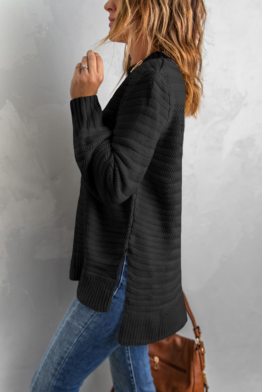 Black solid color sweater with stand collar and textured fabric, featuring long sleeves and a loose fit design.