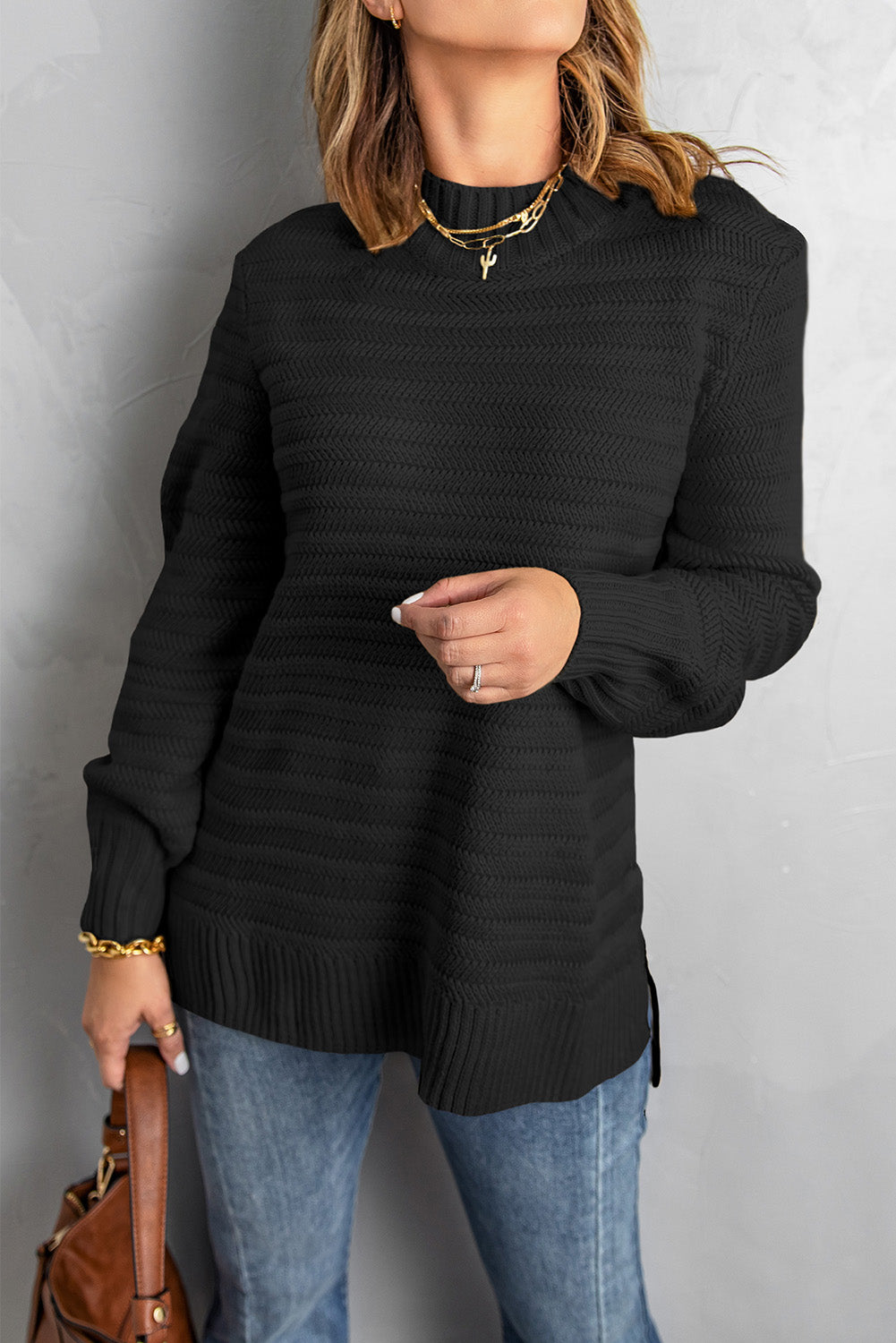 Black solid color sweater with stand collar and textured fabric, featuring long sleeves and a loose fit design.