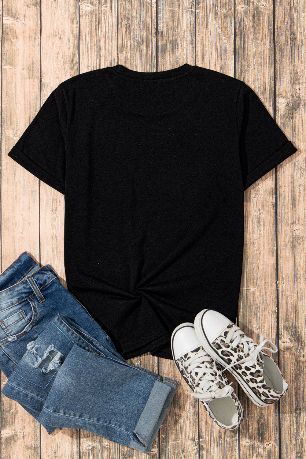 Black t-shirt featuring a sparkling rhinestone smile face graphic, perfect for casual wear.