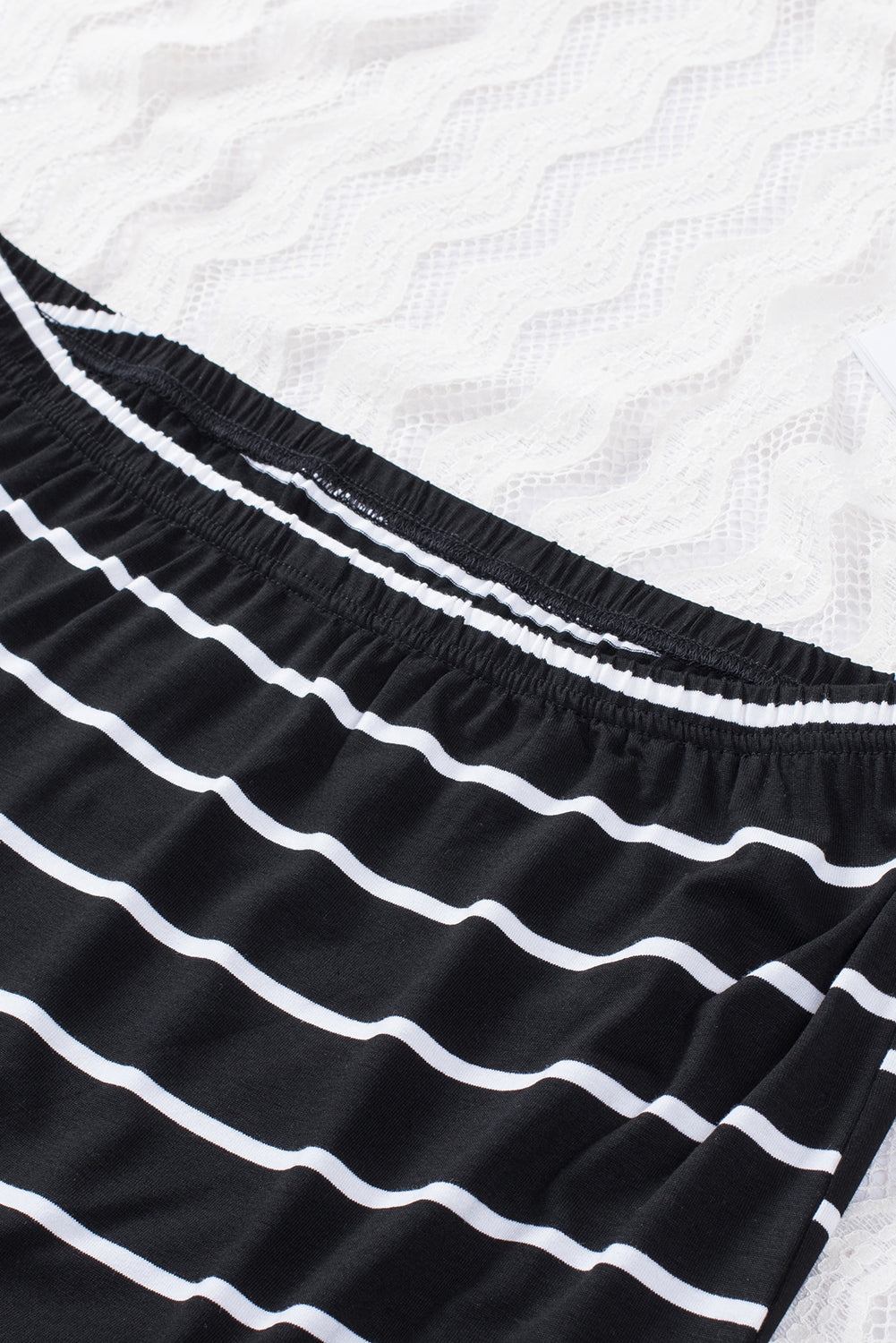 Black Striped Strapless Bandeau Tank showcasing a classic striped pattern, perfect for summer styling.