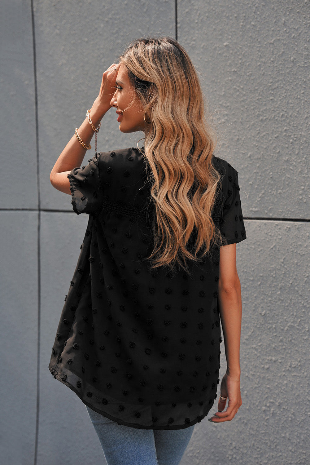 Black Swiss Dot Short Sleeve Flowy Top featuring a chic babydoll style with a soft, sheer fabric and elegant swiss dot texture.