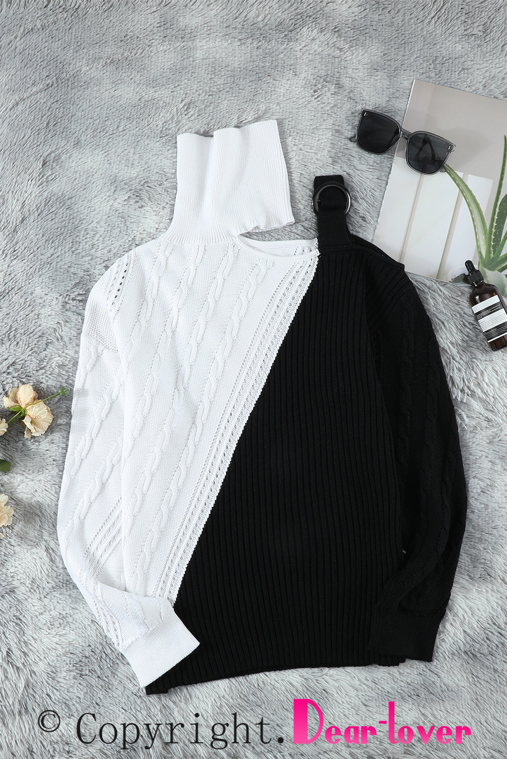 A stylish black turtleneck sweater featuring cold shoulder design and buckled decor, perfect for chic winter outfits.