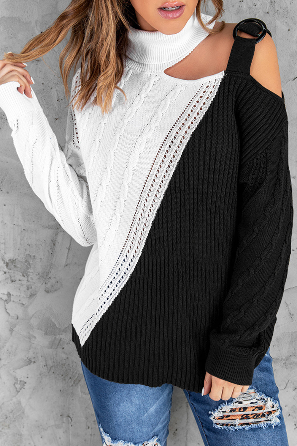 A stylish black turtleneck sweater featuring cold shoulder design and buckled decor, perfect for chic winter outfits.