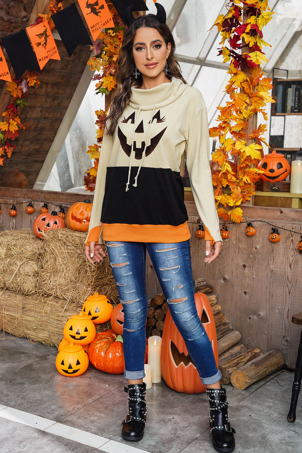 Black turtleneck top with pumpkin print, perfect for Halloween festivities, featuring long sleeves and a trendy color block design.