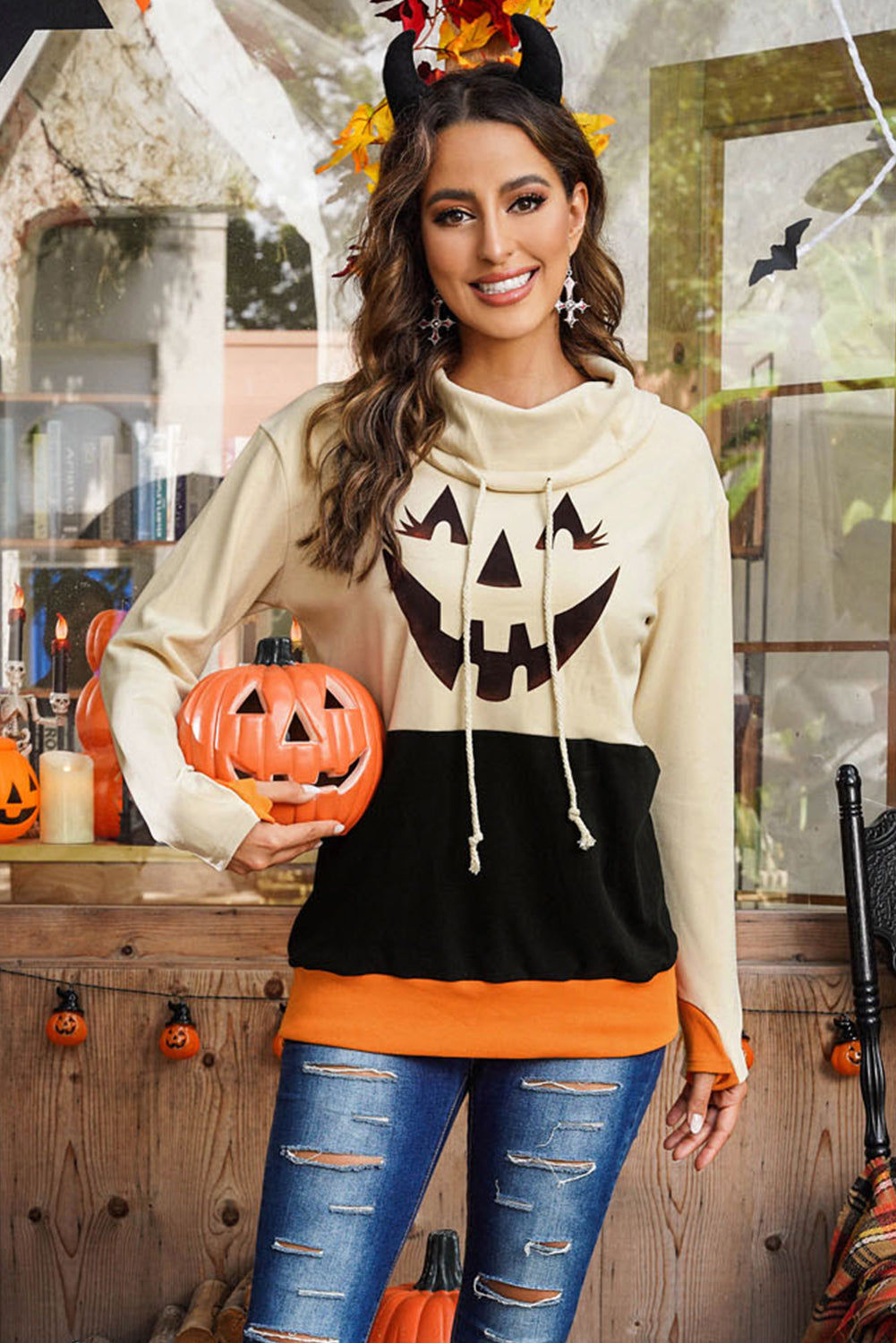 Black turtleneck top with pumpkin print, perfect for Halloween festivities, featuring long sleeves and a trendy color block design.