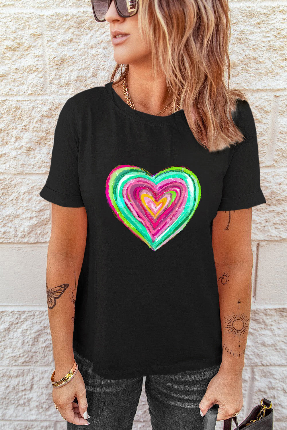 Black crew neck t-shirt featuring a heart-shaped print, perfect for Valentine's Day celebrations.