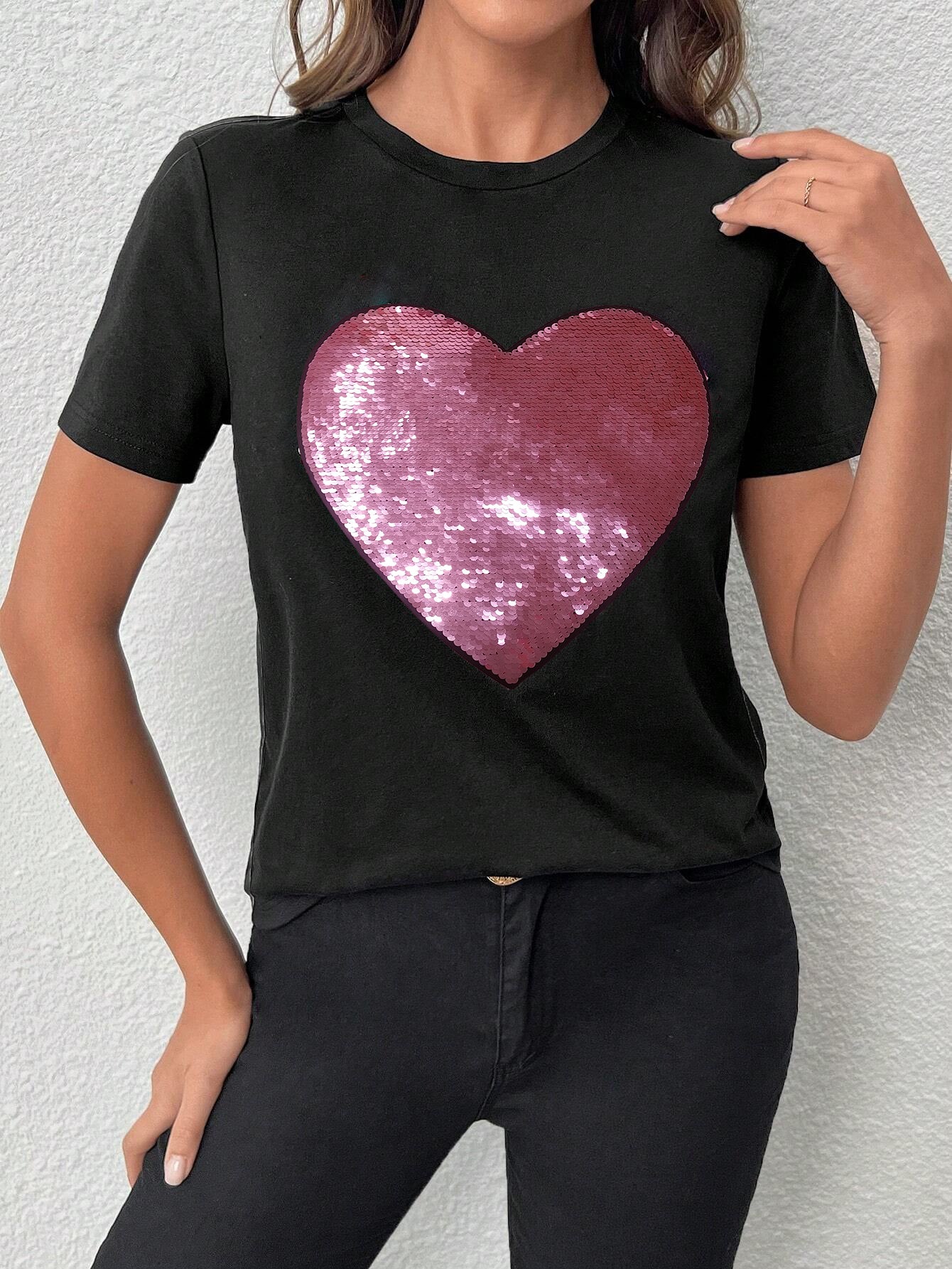 Black crew neck t-shirt featuring a sparkling heart-shaped sequin design, perfect for Valentine's Day celebrations.