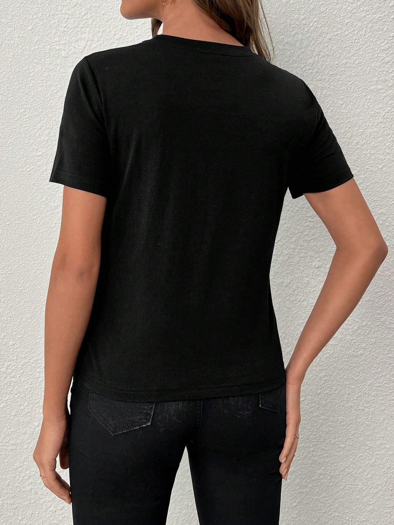 Black crew neck t-shirt featuring a sparkling heart-shaped sequin design, perfect for Valentine's Day celebrations.