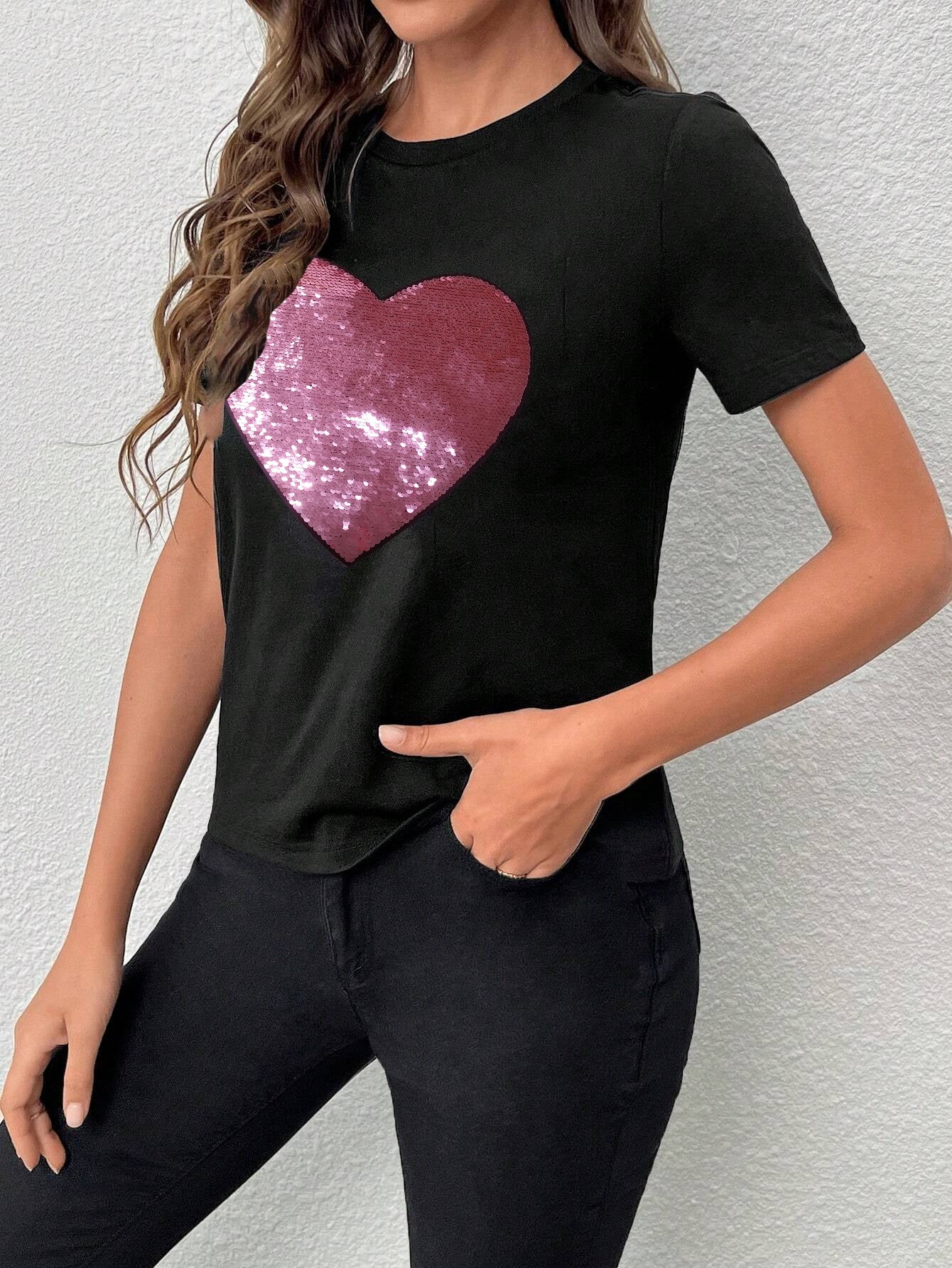 Black crew neck t-shirt featuring a sparkling heart-shaped sequin design, perfect for Valentine's Day celebrations.