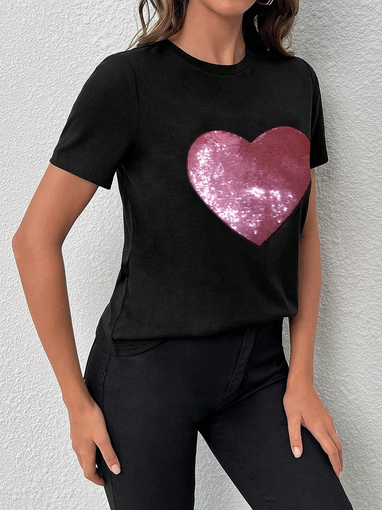 Black crew neck t-shirt featuring a sparkling heart-shaped sequin design, perfect for Valentine's Day celebrations.