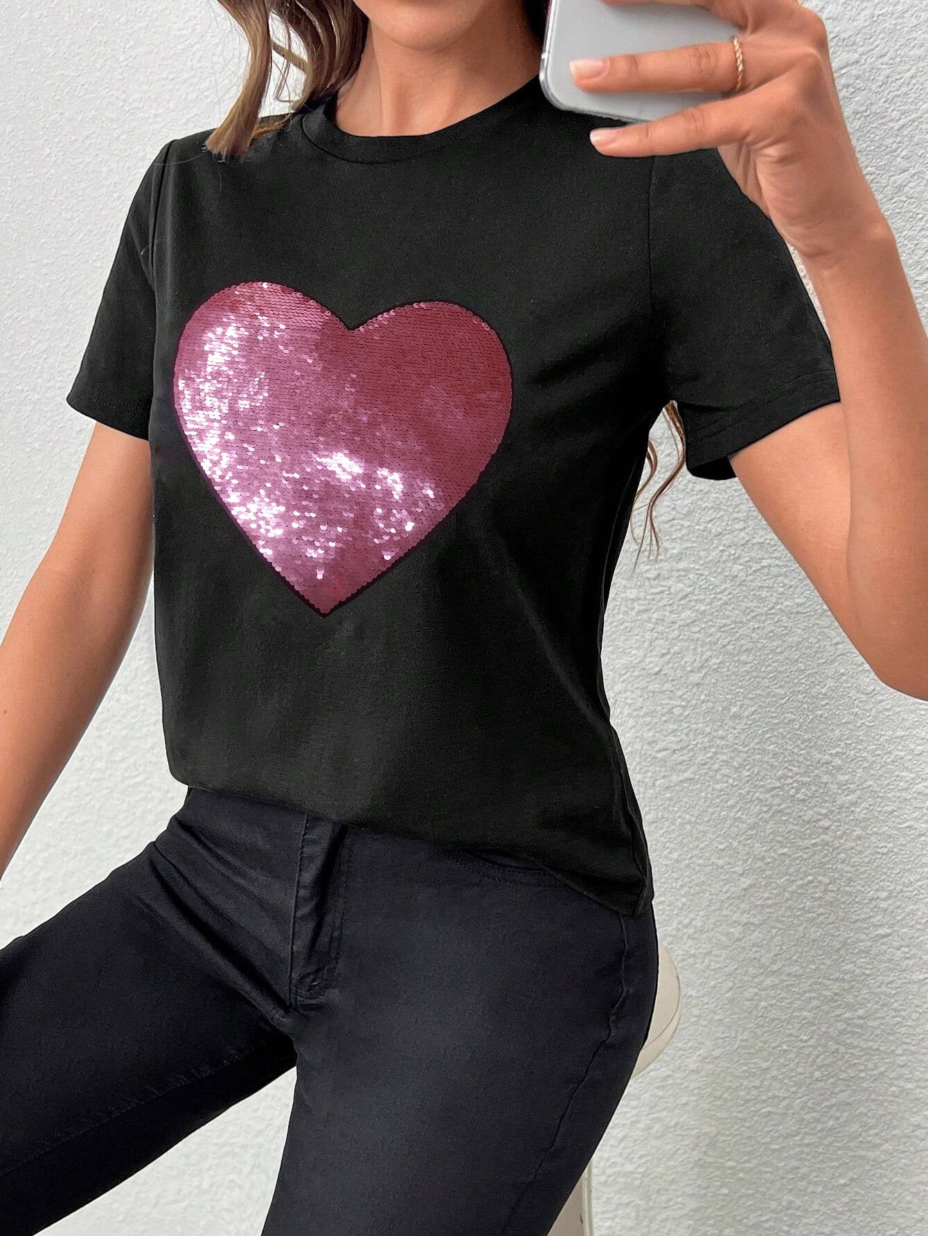 Black crew neck t-shirt featuring a sparkling heart-shaped sequin design, perfect for Valentine's Day celebrations.