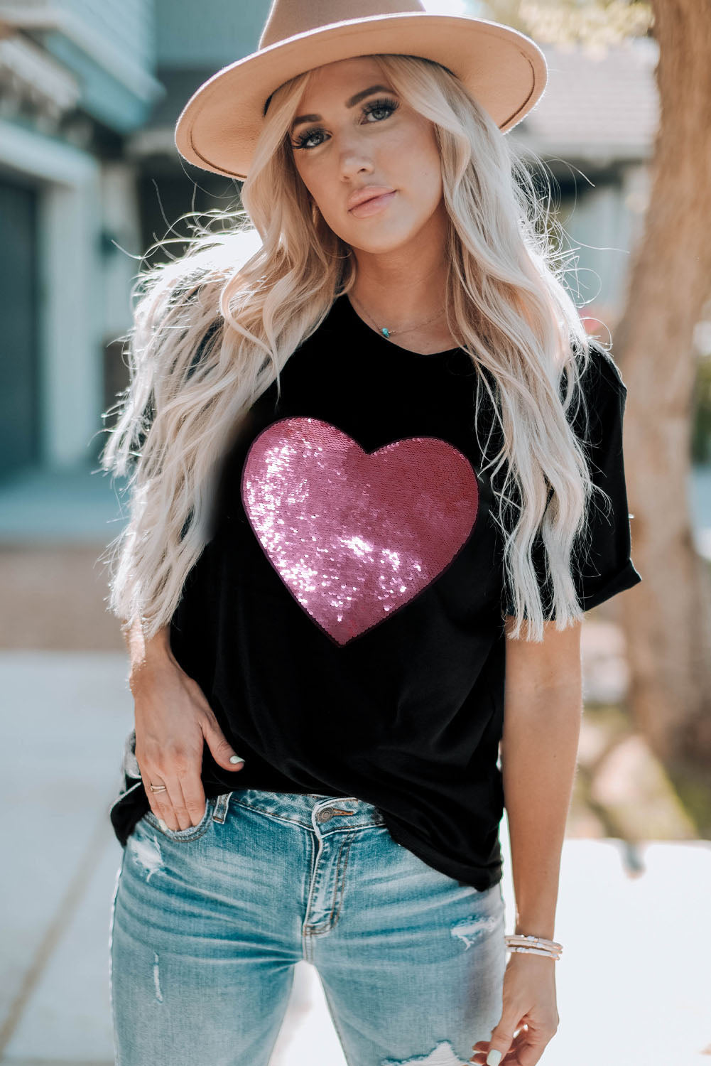 Black crew neck t-shirt featuring a sparkling heart-shaped sequin design, perfect for Valentine's Day celebrations.