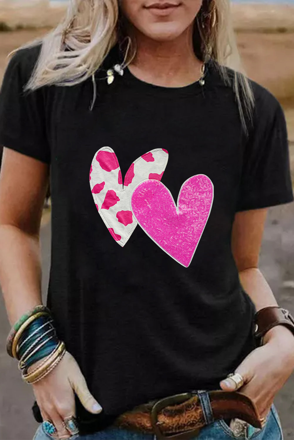 Black Valentines T-shirt featuring double heart design with cow-spots and sequins, perfect for casual wear.