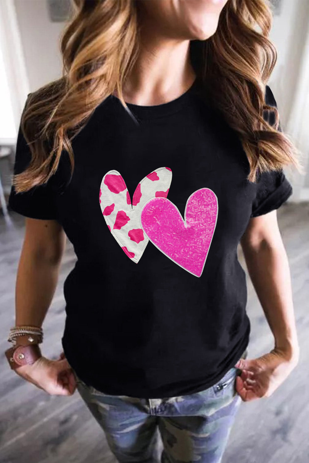 Black Valentines T-shirt featuring double heart design with cow-spots and sequins, perfect for casual wear.