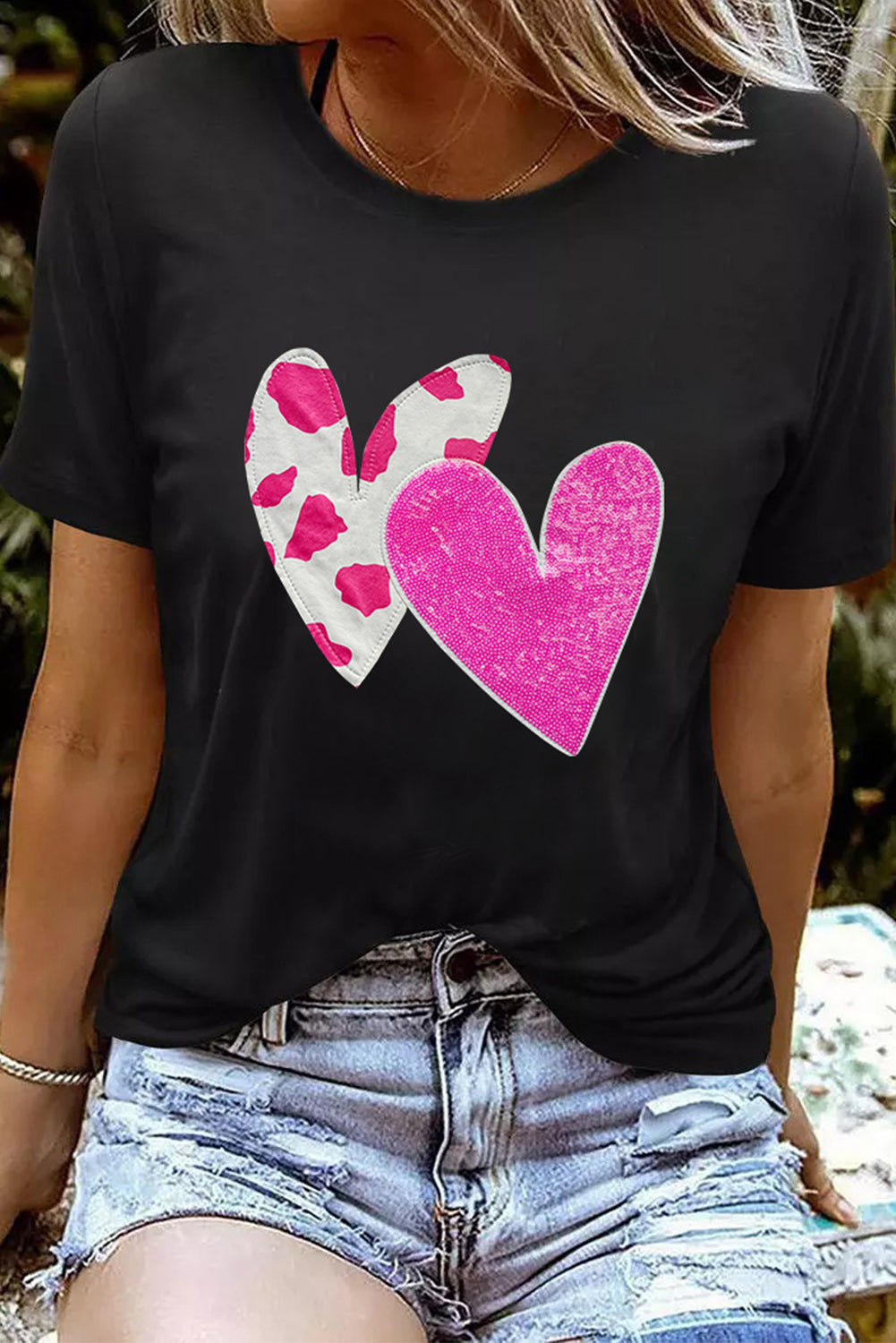 Black Valentines T-shirt featuring double heart design with cow-spots and sequins, perfect for casual wear.