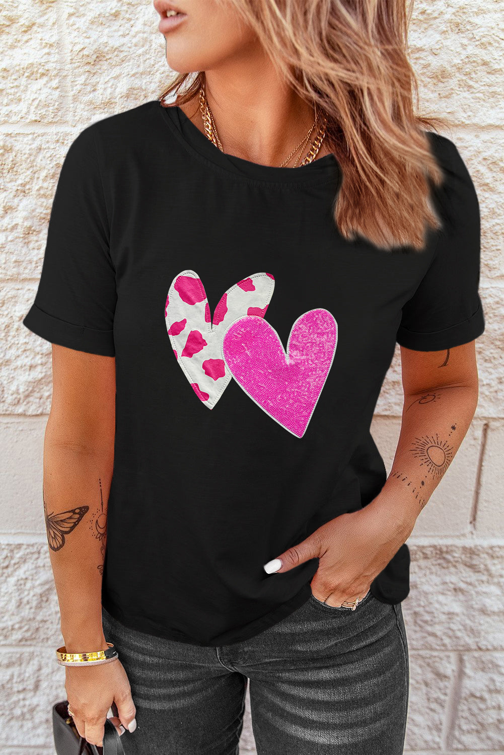 Black Valentines T-shirt featuring double heart design with cow-spots and sequins, perfect for casual wear.