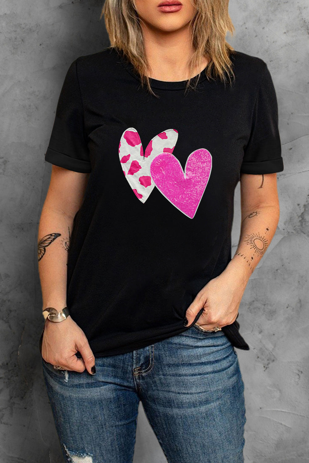 Black Valentines T-shirt featuring double heart design with cow-spots and sequins, perfect for casual wear.