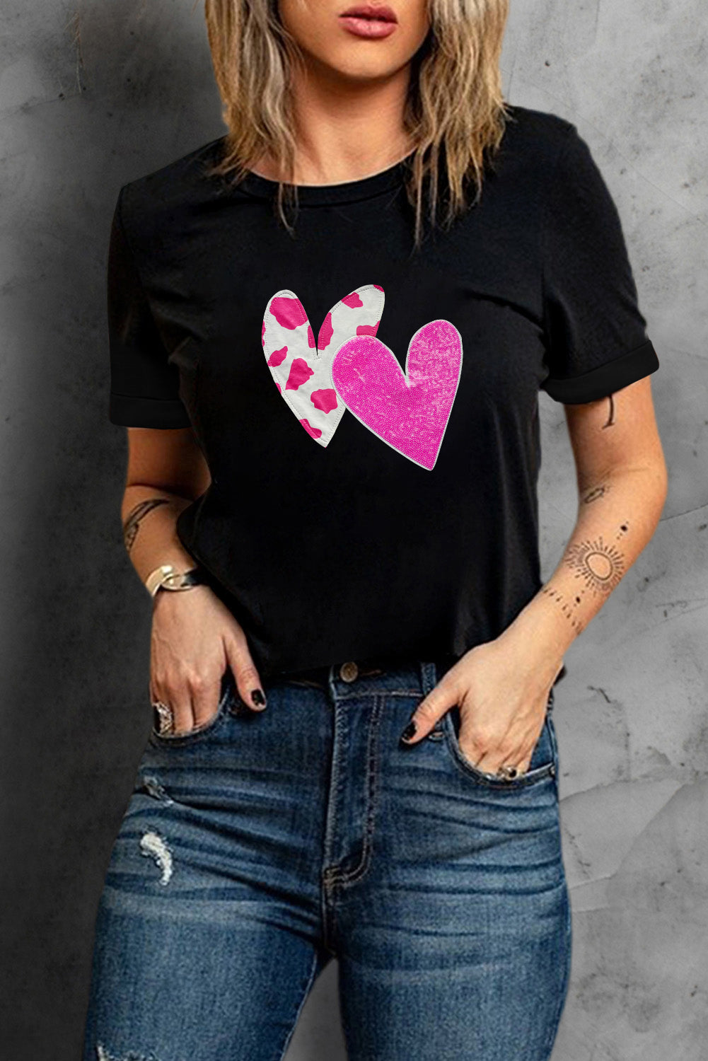 Black Valentines T-shirt featuring double heart design with cow-spots and sequins, perfect for casual wear.