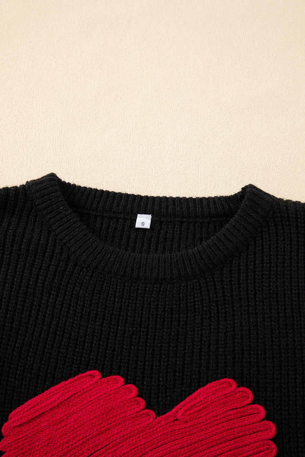 Black round neck sweater featuring a romantic heart sketch design, perfect for winter wear.