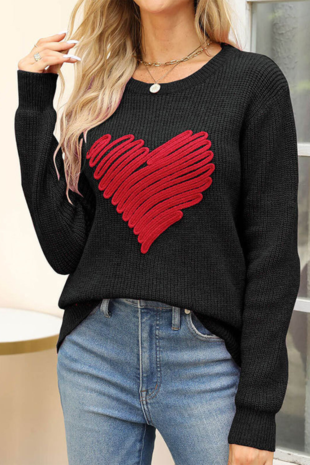 Black round neck sweater featuring a romantic heart sketch design, perfect for winter wear.