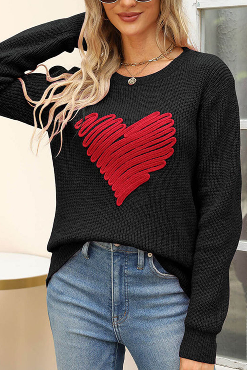 Black round neck sweater featuring a romantic heart sketch design, perfect for winter wear.