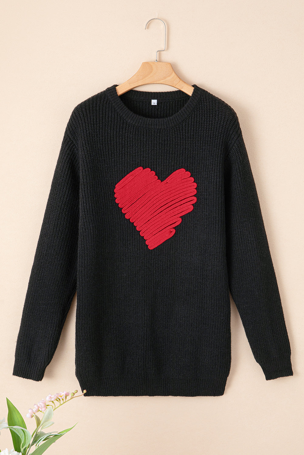 Black round neck sweater featuring a romantic heart sketch design, perfect for winter wear.