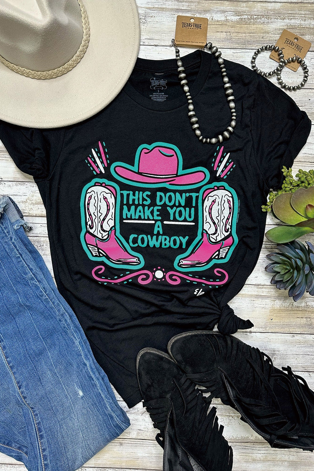 Black crew neck t-shirt featuring a western hat and boots slogan print, showcasing a stylish design for casual wear.