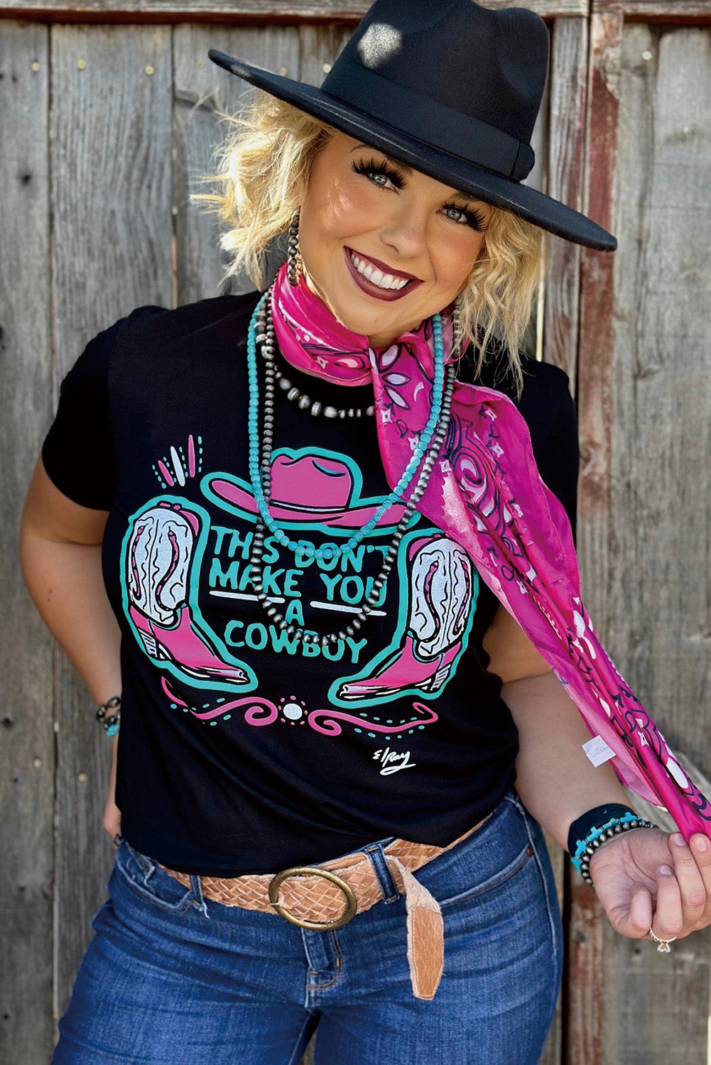 Black crew neck t-shirt featuring a western hat and boots slogan print, showcasing a stylish design for casual wear.