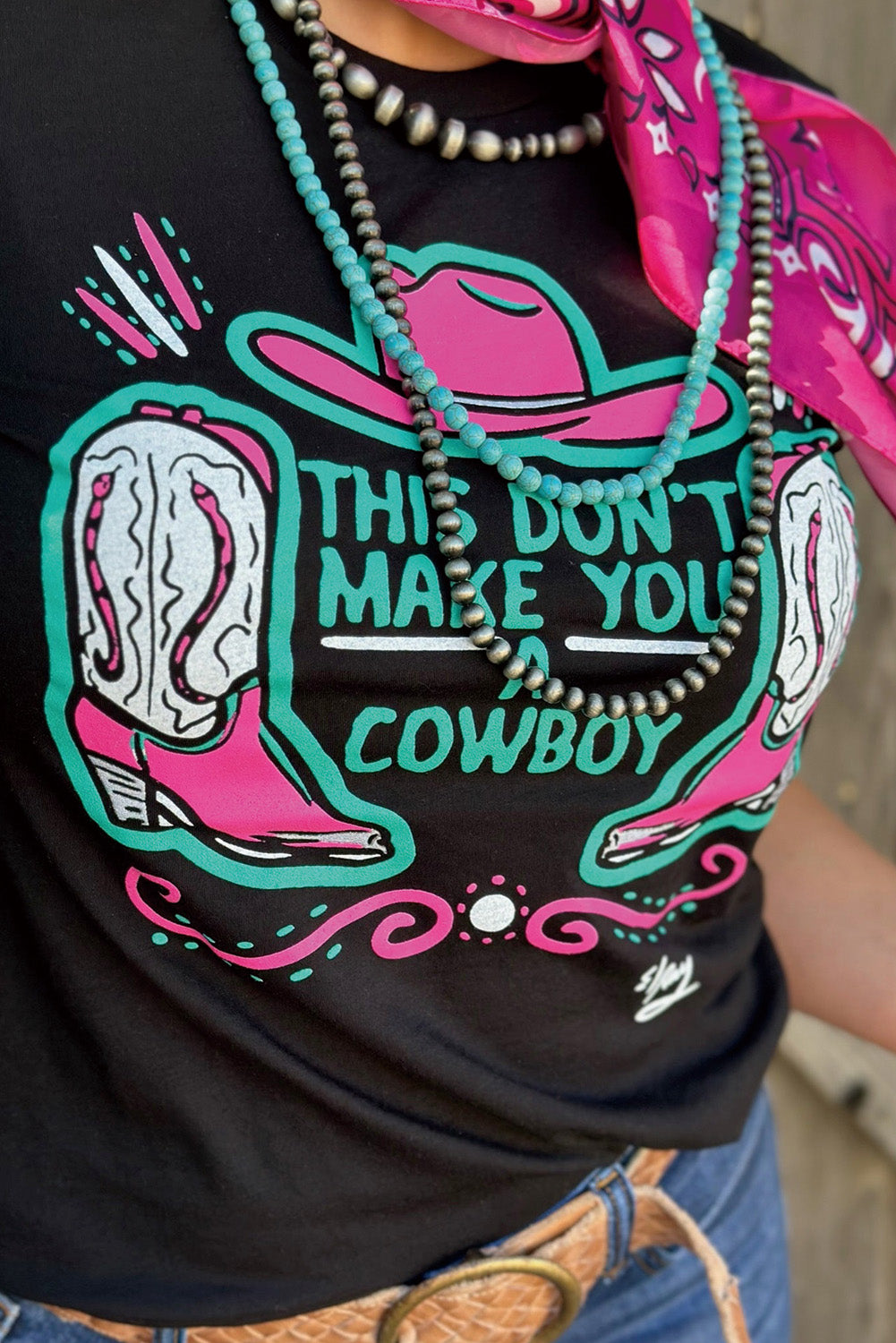 Black crew neck t-shirt featuring a western hat and boots slogan print, showcasing a stylish design for casual wear.