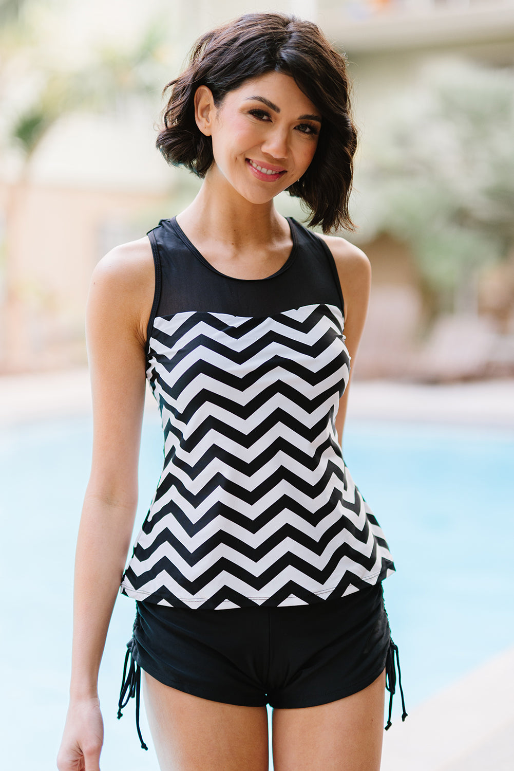 Black and white zigzag print tankini swimsuit featuring a mesh splice design and matching boyshort swim bottom.