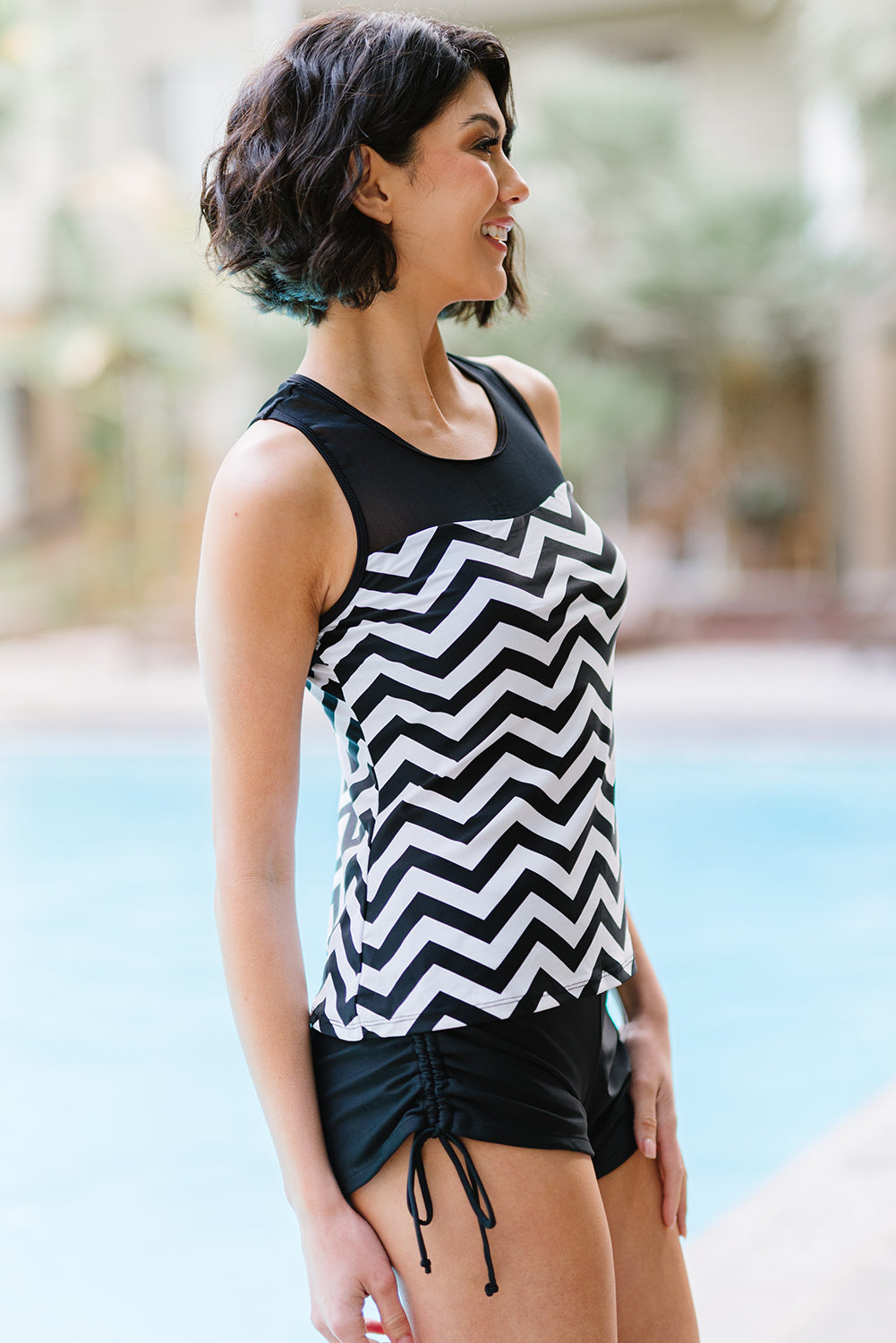 Black and white zigzag print tankini swimsuit featuring a mesh splice design and matching boyshort swim bottom.