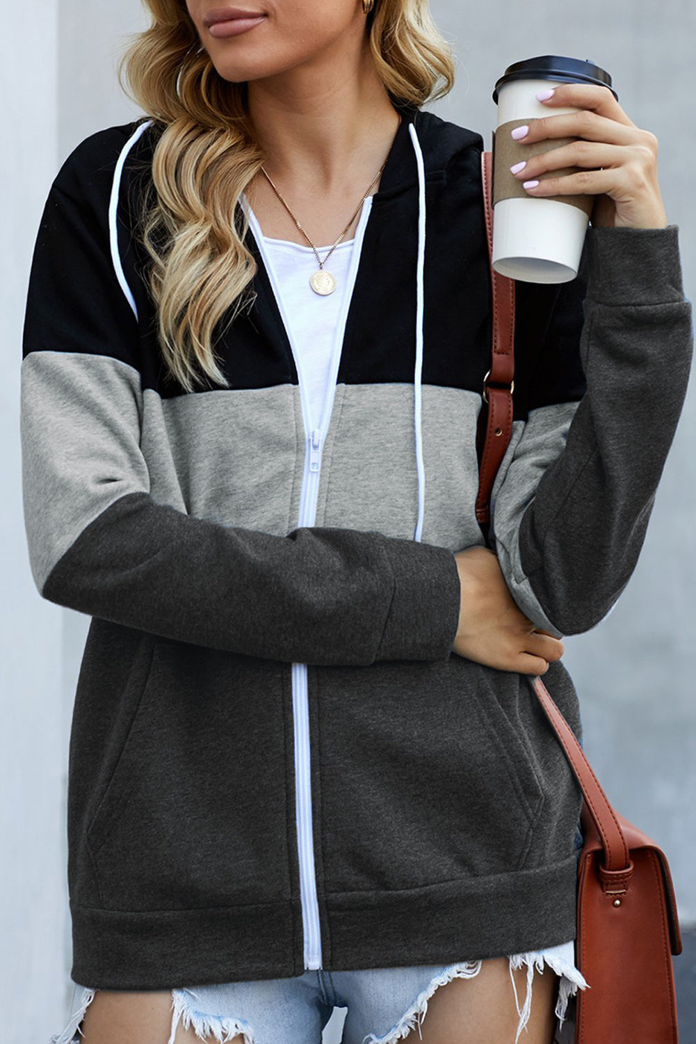 Black zip front hoodie featuring color block splicing and drawstring hood, perfect for casual wear.